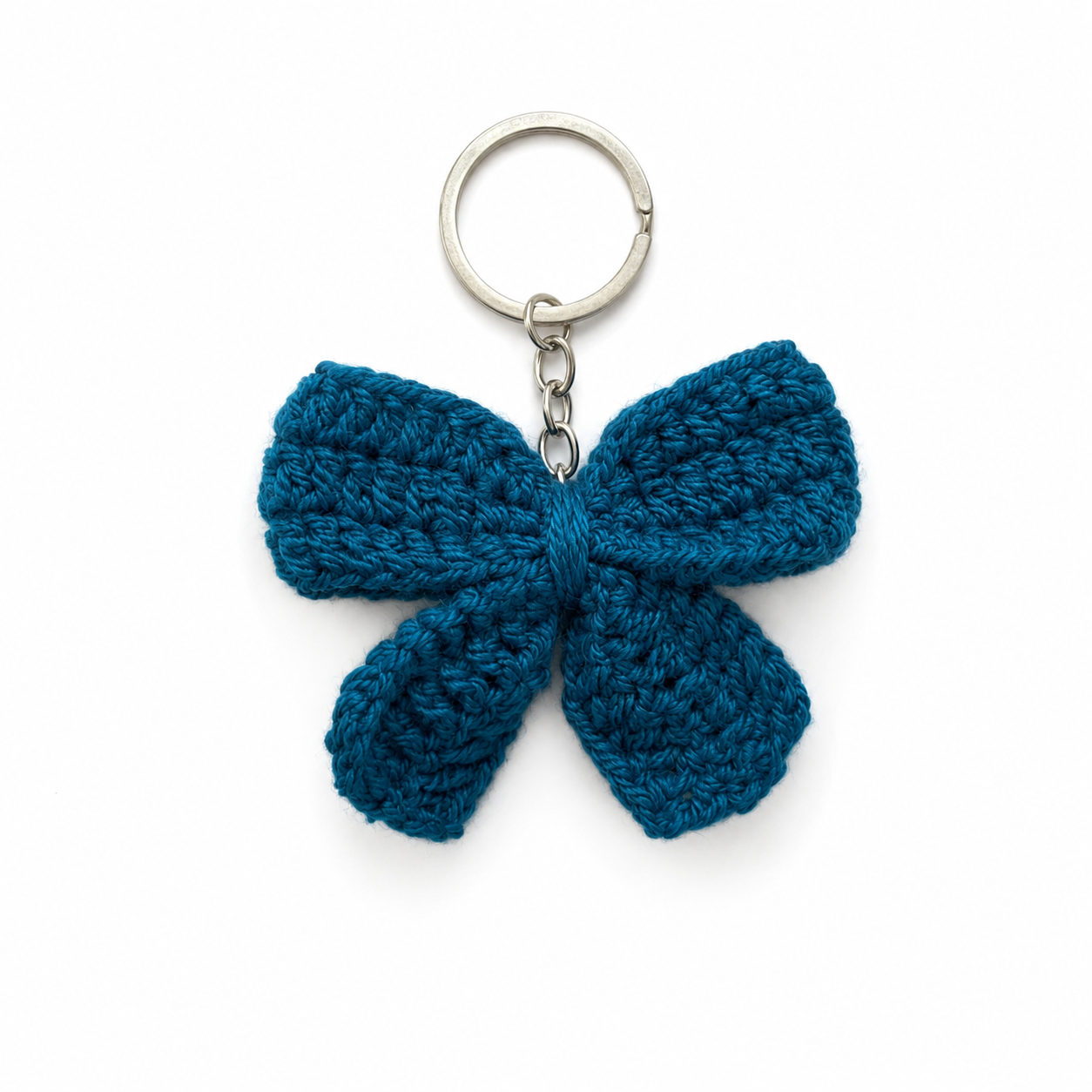 A teal blue crocheted bow keychain with a silver metal split ring and chain, shown on a plain white background.
