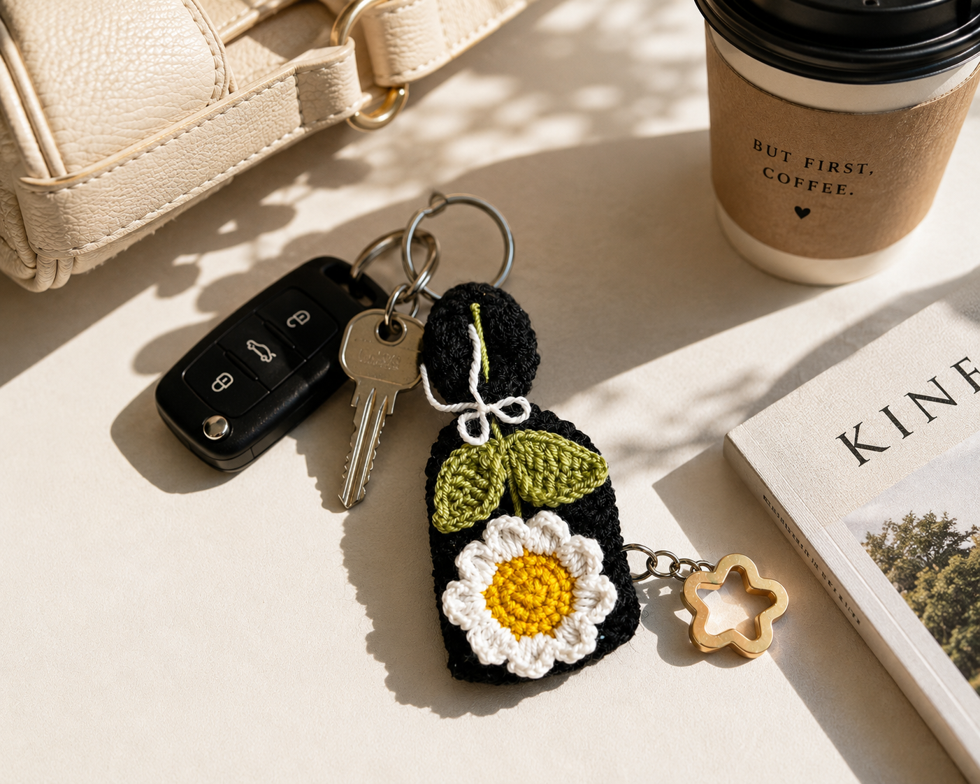 Handmade daisy crochet bag charm and keyring styled with everyday accessories